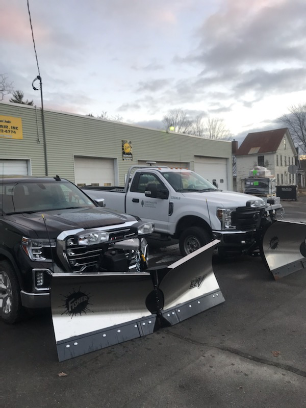 Pickup trucks with Fisher EZ-V snow plows ready for install