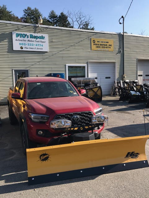 Red Toyota Tacoma with a Fisher HS snow plow at PTO's Repair